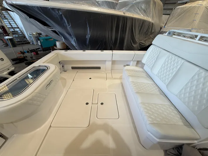  Yacht Photos Pics 2022 Invincible 39 Open Fisherman boat interior with white seating and storage compartments.