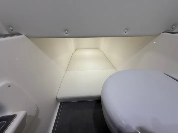  Yacht Photos Pics Interior cabin of 2022 Invincible 39 Open Fisherman boat, featuring a compact toilet.