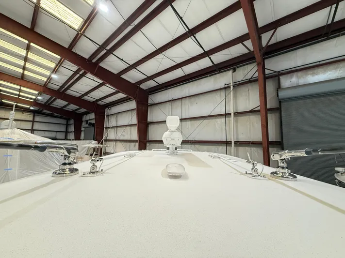  Yacht Photos Pics 2022 Invincible 39 Open Fisherman boat in a warehouse, viewed from the bow.