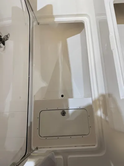  Yacht Photos Pics 2022 Invincible 39 Open Fisherman boat storage compartment, white interior.