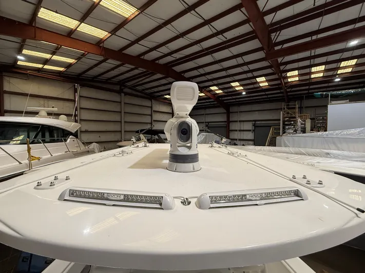  Yacht Photos Pics 2022 Invincible 39 Open Fisherman boat in a warehouse, showcasing deck and equipment.