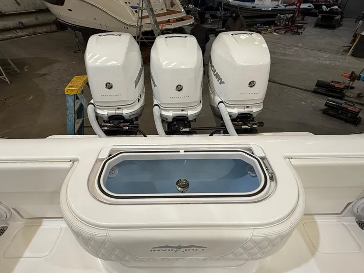  Yacht Photos Pics 2022 Invincible 39 Open Fisherman with triple Mercury outboard engines in a showroom.