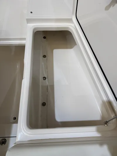  Yacht Photos Pics 2022 Invincible 39 Open Fisherman storage compartment, white interior, open lid.
