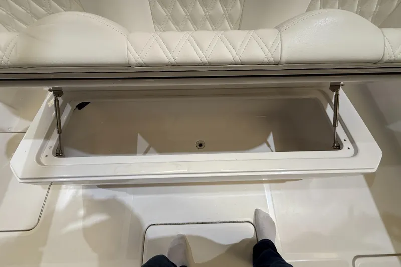  Yacht Photos Pics Open storage compartment on 2022 Invincible 39 Open Fisherman boat with cushioned seating.