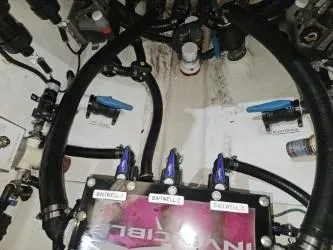  Yacht Photos Pics Engine compartment of a 2022 Invincible 39 Open Fisherman boat, showing hoses and valves.