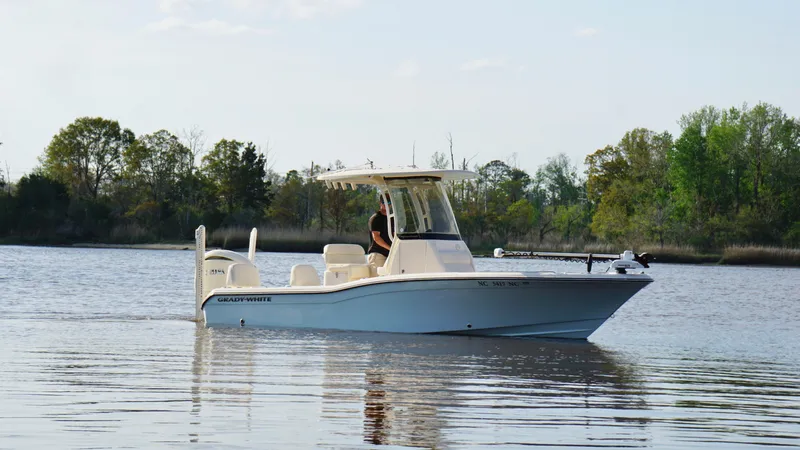  Yacht Photos Pics 2024 Grady-White 231 Coastal Explorer boat cruising on a calm lake.