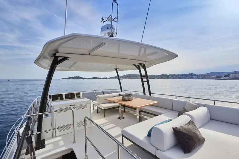 Yacht Photos Pics Luxurious Prestige M48 yacht deck with seating, table, and ocean view, 2025 model.