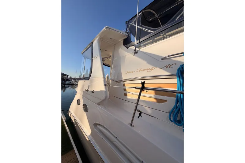 Island Time Yacht Photos Pics 1998 Sea Ray 420 Aft Cabin yacht docked, showcasing sleek design and blue rope detail.