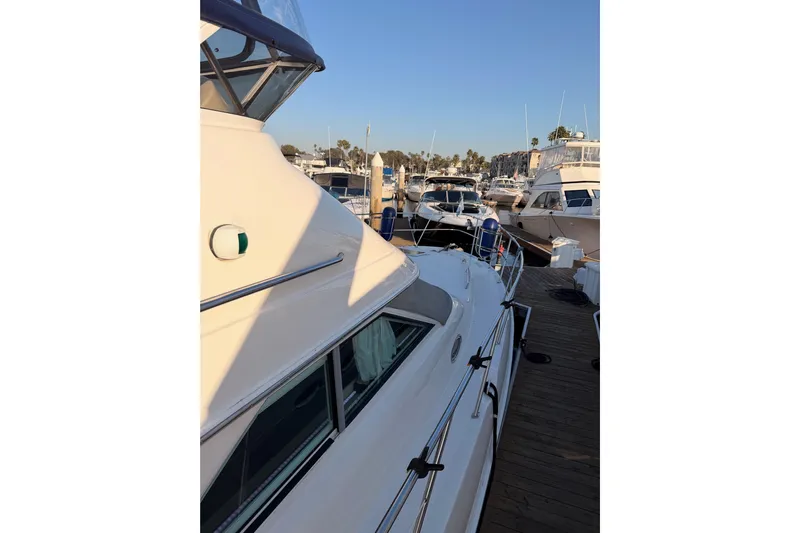 Island Time Yacht Photos Pics 1998 Sea Ray 420 Aft Cabin yacht docked at marina, side view.