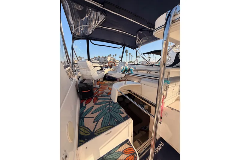 Island Time Yacht Photos Pics 1998 Sea Ray 420 Aft Cabin interior with floral carpet and white seating.