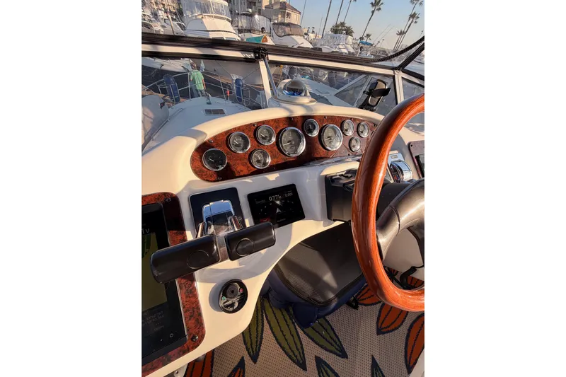 Island Time Yacht Photos Pics 1998 Sea Ray 420 Aft Cabin helm with gauges and wooden steering wheel.