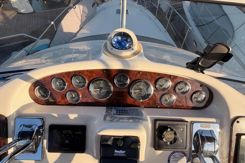 Island Time Yacht Photos Pics Control panel of a 1998 Sea Ray 420 Aft Cabin yacht with gauges and compass.