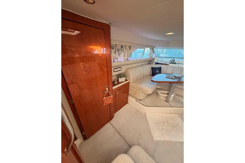 Island Time Yacht Photos Pics Luxurious interior of 1998 Sea Ray 420 Aft Cabin yacht with elegant seating and wooden finishes.
