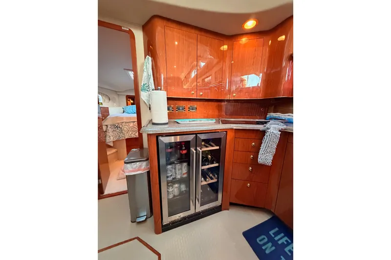Island Time Yacht Photos Pics 1998 Sea Ray 420 Aft Cabin interior with wooden cabinets and mini fridge.