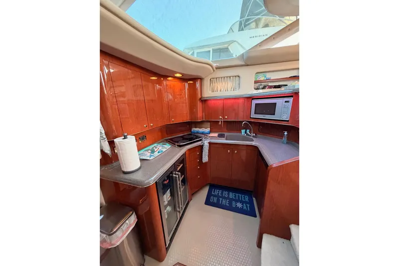 Island Time Yacht Photos Pics 1998 Sea Ray 420 Aft Cabin kitchen with wood cabinets, microwave, and sink.