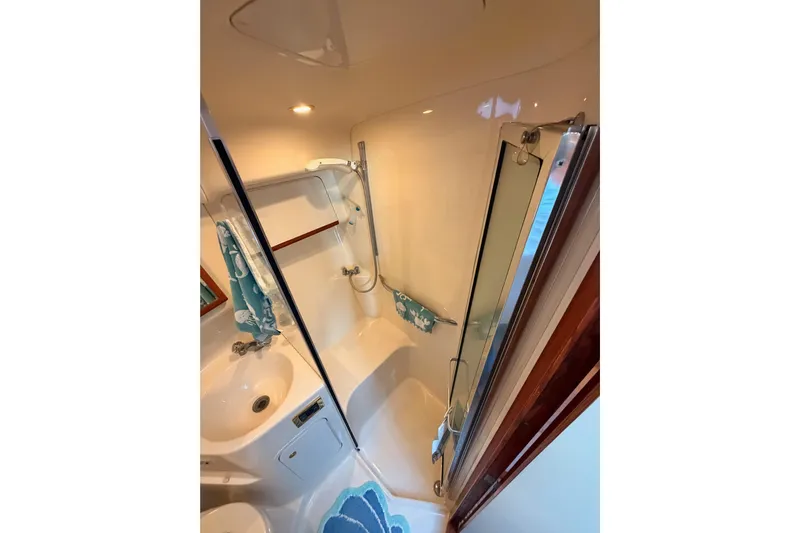 Island Time Yacht Photos Pics Bathroom interior of 1998 Sea Ray 420 Aft Cabin yacht, featuring shower and sink.