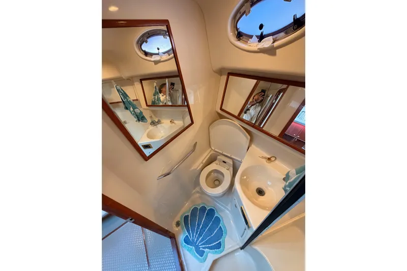 Island Time Yacht Photos Pics Bathroom interior of 1998 Sea Ray 420 Aft Cabin yacht with mirror and porthole.