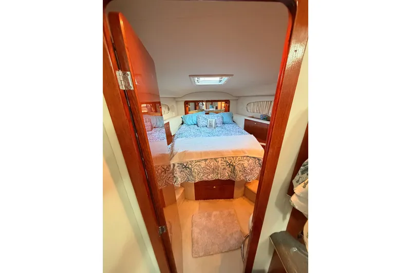 Island Time Yacht Photos Pics Cozy bedroom in 1998 Sea Ray 420 Aft Cabin yacht with elegant wood finish.