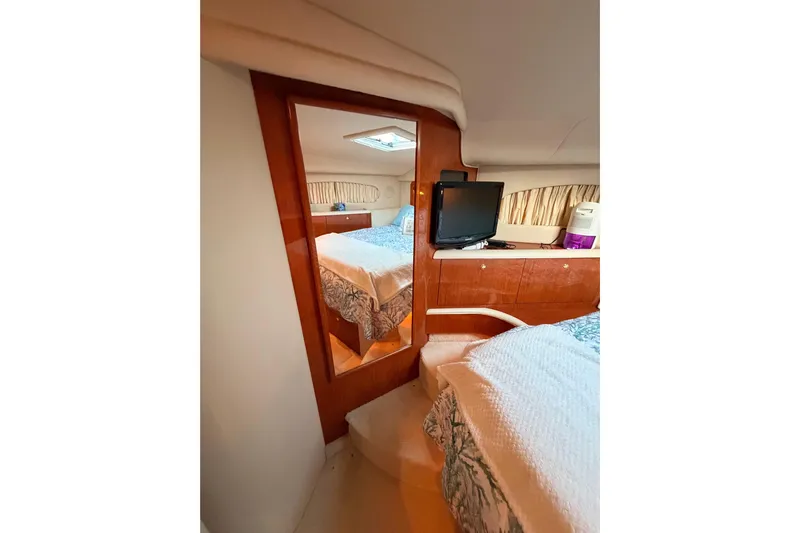 Island Time Yacht Photos Pics 1998 Sea Ray 420 Aft Cabin interior with bed, TV, and wooden accents.