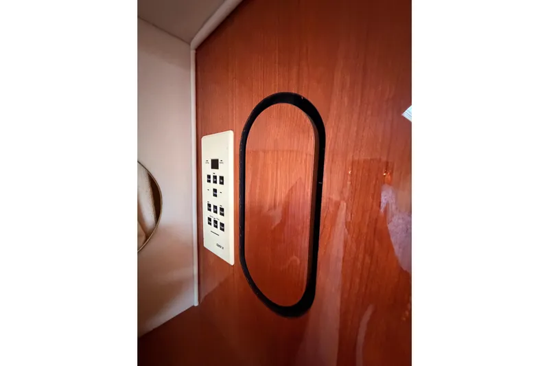 Island Time Yacht Photos Pics Control panel on 1998 Sea Ray 420 Aft Cabin's wooden interior wall.