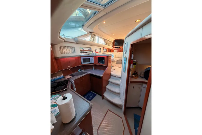 Island Time Yacht Photos Pics Interior of 1998 Sea Ray 420 Aft Cabin yacht with kitchen and seating area.