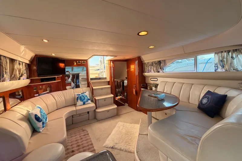 Island Time Yacht Photos Pics Luxurious interior of 1998 Sea Ray 420 Aft Cabin yacht with plush seating and elegant decor.
