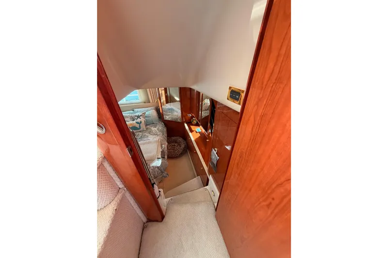 Island Time Yacht Photos Pics Interior view of 1998 Sea Ray 420 Aft Cabin, featuring cozy bedroom and wooden finishes.