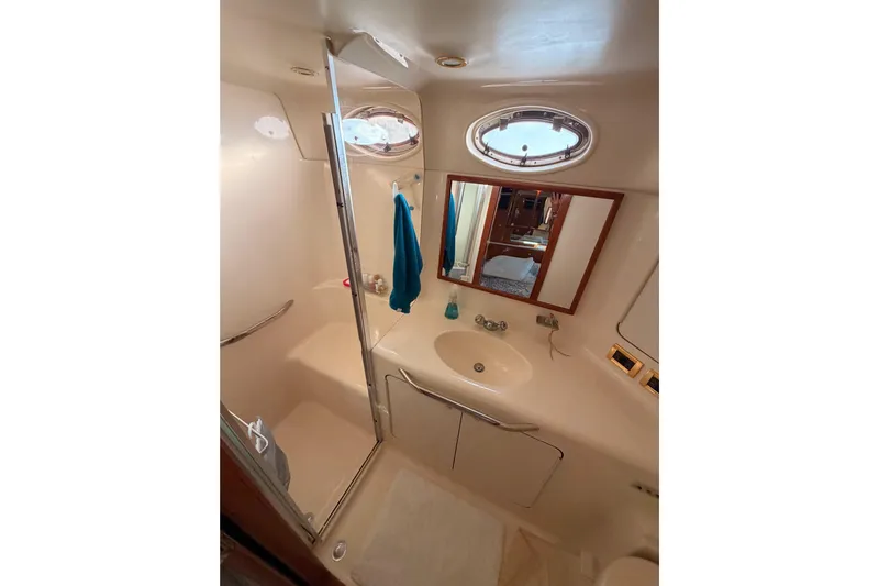 Island Time Yacht Photos Pics Bathroom interior of 1998 Sea Ray 420 Aft Cabin yacht, featuring shower and sink.