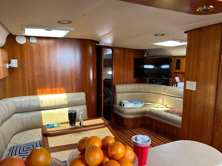 Dividend Yacht Photos Pics Interior of 2000 Tiara Yachts 5000 Express with wood paneling and seating area.