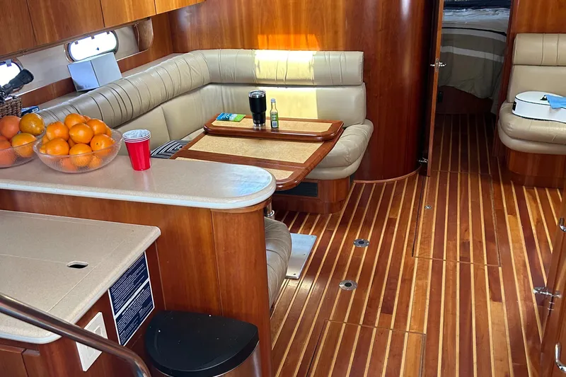 Dividend Yacht Photos Pics Interior of 2000 Tiara Yachts 5000 Express with wood flooring and cozy seating area.