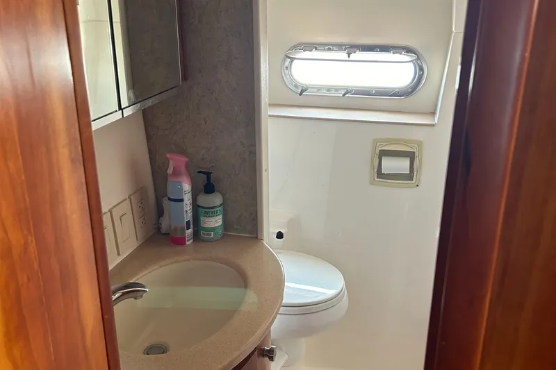 Dividend Yacht Photos Pics Bathroom interior of 2000 Tiara Yachts 5000 Express with sink and window.