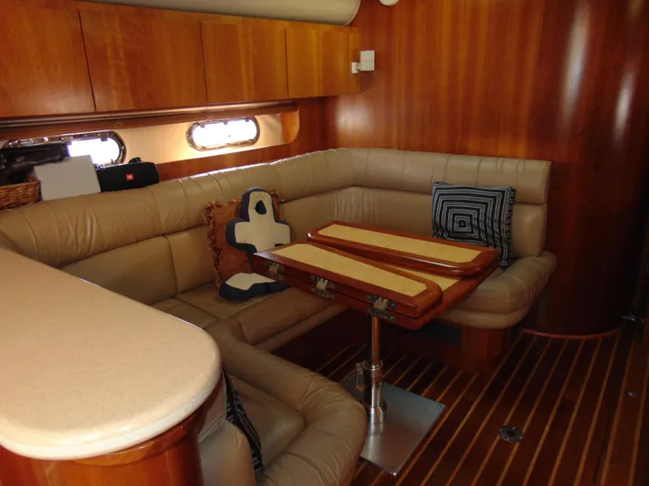 Dividend Yacht Photos Pics Luxurious interior of 2000 Tiara Yachts 5000 Express with leather seating and wooden accents.