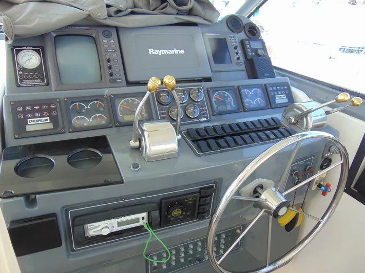 Dividend Yacht Photos Pics Control panel of 2000 Tiara Yachts 5000 Express with steering wheel and navigation instruments.