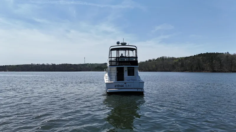 Stress Relief Yacht Photos Pics 2007 Silverton 36 Convertible boat on a calm lake under a clear blue sky.