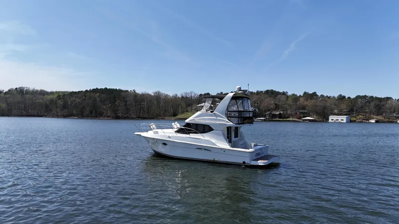 Stress Relief Yacht Photos Pics 2007 Silverton 36 Convertible yacht on a serene lake with wooded shoreline.