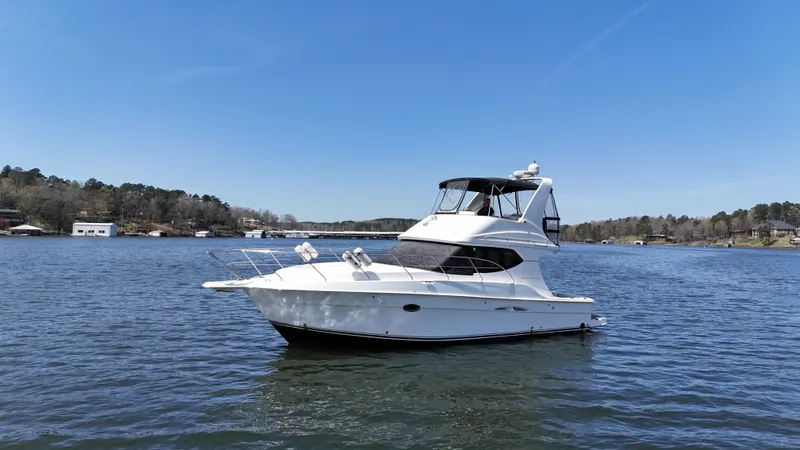 Stress Relief Yacht Photos Pics 2007 Silverton 36 Convertible yacht on a serene lake under a clear blue sky.