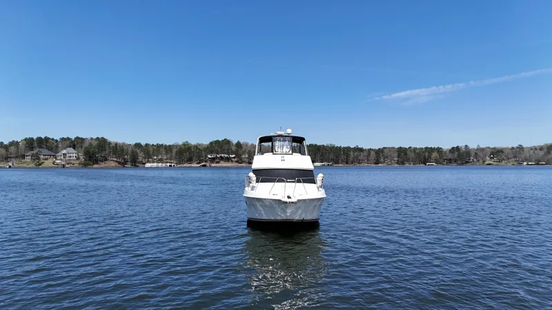 Stress Relief Yacht Photos Pics 2007 Silverton 36 Convertible boat on a calm lake under clear blue sky.