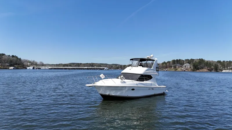 Stress Relief Yacht Photos Pics 2007 Silverton 36 Convertible yacht on a serene lake under clear blue skies.