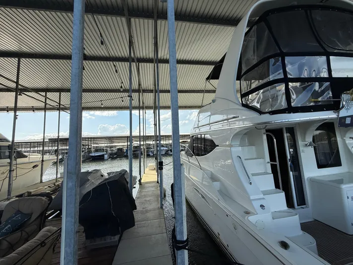 Stress Relief Yacht Photos Pics 2007 Silverton 36 Convertible yacht docked in a marina under a covered shelter.