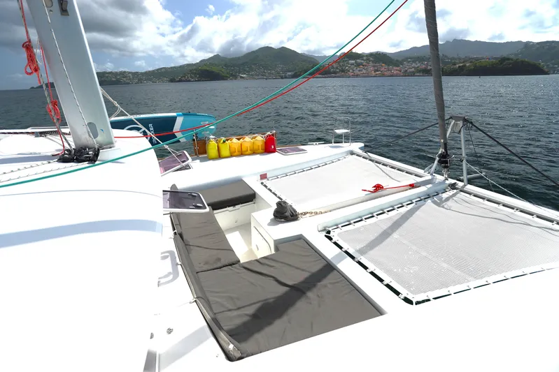 Momentum Yacht Photos Pics Catamaran Lagoon 450 F 2012 on water, featuring deck and scenic coastal backdrop.