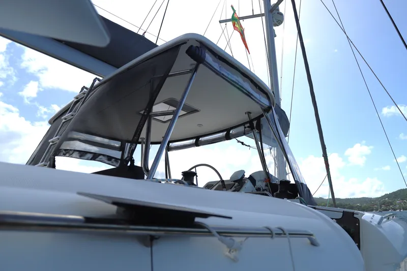 Momentum Yacht Photos Pics 2012 Lagoon 450 F sailboat, close-up of cockpit and mast under clear sky.