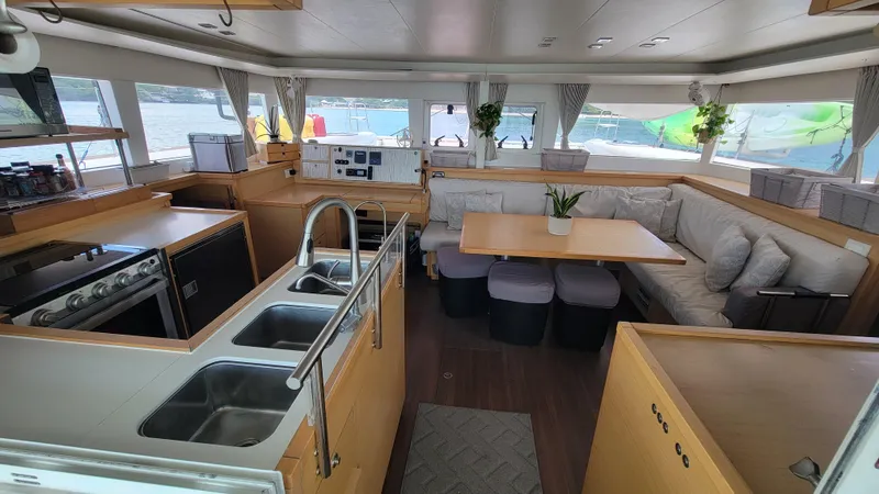 Momentum Yacht Photos Pics Spacious interior of 2012 Lagoon 450 F catamaran with modern kitchen and dining area.
