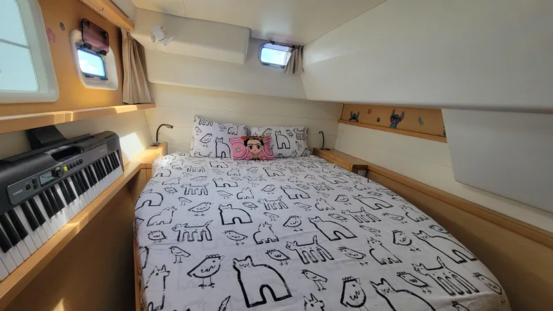 Momentum Yacht Photos Pics Cozy cabin interior of 2012 Lagoon 450 F with bed and keyboard.