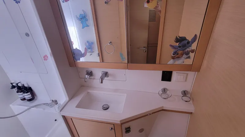 Momentum Yacht Photos Pics Bathroom interior of 2012 Lagoon 450 F yacht with mirror and sink.