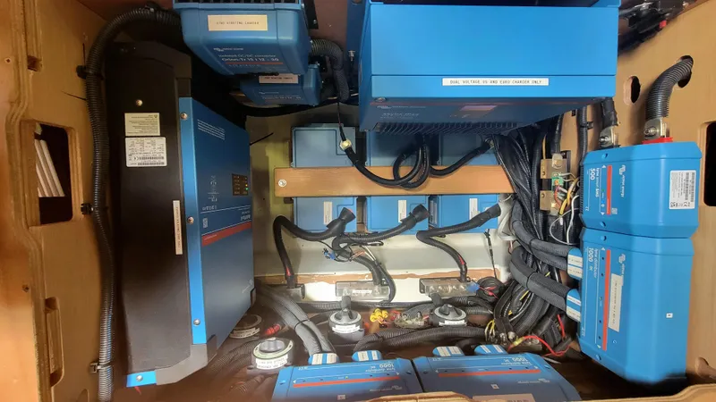 Momentum Yacht Photos Pics Electrical system setup in a 2012 Lagoon 450 F yacht, featuring blue power units and wiring.