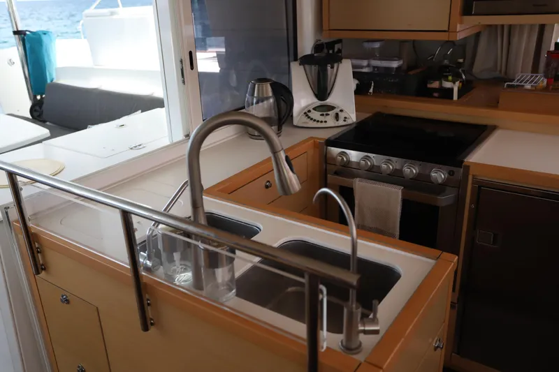 Momentum Yacht Photos Pics Interior of 2012 Lagoon 450 F yacht kitchen with sink, stove, and appliances.