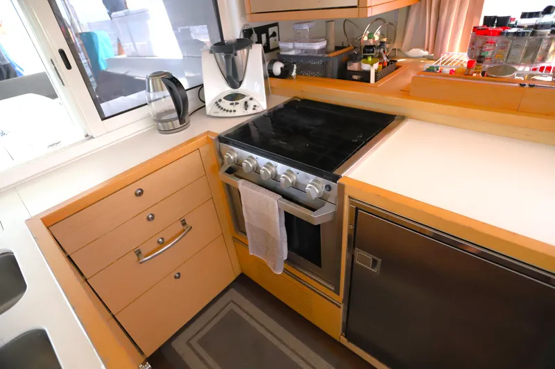 Momentum Yacht Photos Pics Modern kitchen in a 2012 Lagoon 450 F yacht with stove, blender, and storage.