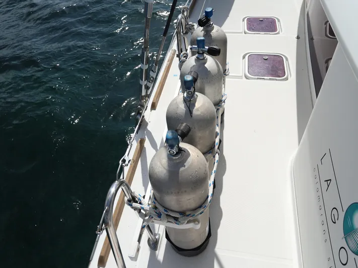 Momentum Yacht Photos Pics Diving tanks on deck of 2012 Lagoon 450 F catamaran, near ocean water.