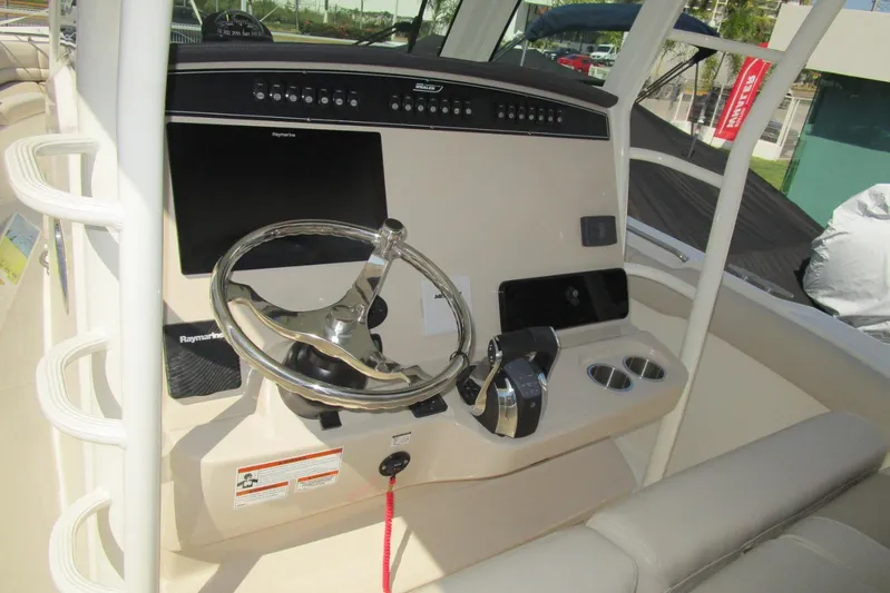 2020 Boston Whaler 330 Or @ Vallarta Yacht Photos Pics 2020 Boston Whaler 330 Outrage helm with steering wheel and control panel.