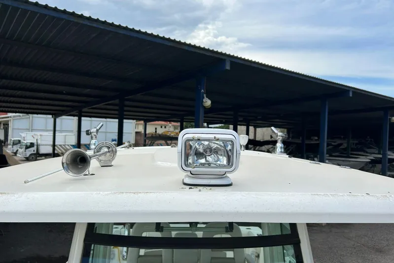 2020 Boston Whaler 330 Or @ Vallarta Yacht Photos Pics 2020 Boston Whaler 330 Outrage boat with spotlight and horn under covered storage.